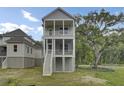 Charming two-story home with a white garage, inviting porch, and meticulously landscaped front yard at 3029 Robeson Trce, Johns Island, SC 29455