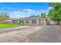 Single story home with a long driveway, gravel parking area, and a large yard at 337 Price St, Goose Creek, SC 29445