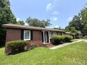 Single-story brick home featuring a covered porch, and classic black shutters at 36 Guerry Cir, Goose Creek, SC 29445