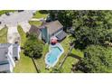 Aerial view showcasing the backyard oasis with a pool, surrounded by lush landscaping and neighborhood charm at 3813 Battleview Ct, North Charleston, SC 29420