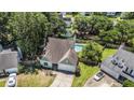 Birds eye view showing a well maintained home with a spacious driveway and an inviting backyard pool at 3813 Battleview Ct, North Charleston, SC 29420