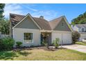 Charming single-Gathering home features a well-manicured lawn, two-car garage, and inviting front entrance at 3813 Battleview Ct, North Charleston, SC 29420