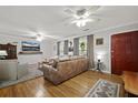 Inviting living room with hardwood floors, a comfortable leather sofa, and bright natural light at 401 Amy Dr, Goose Creek, SC 29445