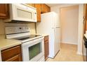 Functional kitchen featuring white appliances, oak cabinets and plenty of counter space at 403 Sunny Side Way, Summerville, SC 29485