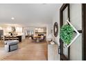 Bright entryway leading to the living room with hardwood floors, dining area, and open-concept kitchen at 403 Wedgewood St, Charleston, SC 29407