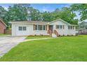 Charming single-story home with fresh paint, shutters, and a well-maintained lawn at 4233 Oakridge Dr, North Charleston, SC 29418