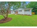 Beautiful single-story home with fresh paint, shutters, and a well-maintained lawn at 4233 Oakridge Dr, North Charleston, SC 29418