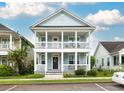 Inviting two-story home features a charming double porch, surrounded by well-maintained landscaping at 4953 W Liberty Park Cir, North Charleston, SC 29405