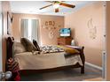 Comfortable bedroom featuring a decorative bed, ceiling fan, window, and warm neutral color scheme at 508 Glady Rd, Moncks Corner, SC 29461