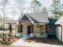 Inviting front porch with brick pillars, wood accents, and a stylish entrance door, offering a warm welcome at 54 Summer Dr, Walterboro, SC 29488
