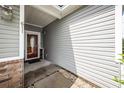 Home entry featuring gray siding and brick accents around the front door at 611 Grassy Hill Rd, Summerville, SC 29483