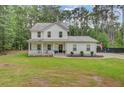 Beautiful two-story home with a covered front porch and well-maintained lawn, exuding curb appeal at 6190 Button Bush Dr, Ravenel, SC 29470