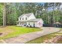 Spacious home with a long driveway, lush lawn, and privacy fence, perfect for Gathering living at 6190 Button Bush Dr, Ravenel, SC 29470