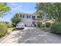Inviting two-story home boasting a two-car garage, a long driveway, and manicured greenery at 67 Regency Oaks Dr, Summerville, SC 29485