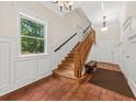 Inviting foyer featuring a staircase, tile floor, and a view of the outdoors at 6840 Early Jersey Rd, Meggett, SC 29449