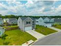 Beautiful two-story home with a large lawn and a two-car garage at 716 Mcroy St, Moncks Corner, SC 29461