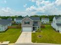 Attractive two-story home with a green lawn and two-car garage at 716 Mcroy St, Moncks Corner, SC 29461