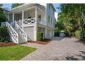 Elegant home exterior featuring white siding, welcoming front porch, and a paved driveway at 924 Mciver St, Mount Pleasant, SC 29464