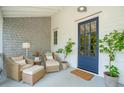 Cozy front porch with wicker chairs, a side table, and a blue front door at 924 Mciver St, Mount Pleasant, SC 29464