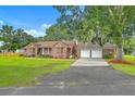 Charming brick home with well-manicured lawn and a convenient attached three-car garage at 1023 Striper Ave, Moncks Corner, SC 29461