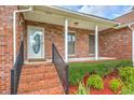 Inviting front porch with brick steps and railing leading to a classic front door at 1023 Striper Ave, Moncks Corner, SC 29461