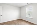 Bright bedroom with wood-look floors and natural light from a large window at 103 River Hill Rd, Goose Creek, SC 29445