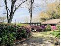Beautiful backyard with a winding path bordered by azaleas leading to an outbuilding at 1039 Grand Concourse St, Charleston, SC 29412