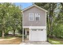 Charming two-story home with gray siding, white trim, attached garage, and a cozy front porch at 110 Farm Rd # A, Goose Creek, SC 29445