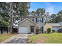 Inviting two-story home with a well-manicured lawn, attached garage, and classic curb appeal at 110 Yorkshire Dr, Summerville, SC 29483