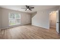 Bright living room featuring hardwood floors, a ceiling fan, and a large window at 110 Yorkshire Dr, Summerville, SC 29483