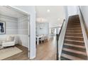 Inviting foyer with wood floors, stairs, and a view of the dining room at 112 Orchard Blossom Ln, Summerville, SC 29485