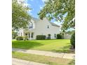 Side view of a two-story home showing well-maintained landscaping, a lush lawn, and classic siding at 113 Rockdale Ln, Goose Creek, SC 29445