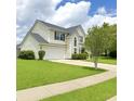 Well-maintained two-story home features a lush green lawn, two-car garage, and a classic architectural design at 113 Rockdale Ln, Goose Creek, SC 29445