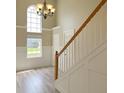 Bright foyer with hardwood floors, stairs with white railings, and a large arched window providing natural light at 113 Rockdale Ln, Goose Creek, SC 29445