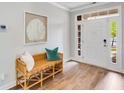Inviting foyer with a decorative bench and framed art accenting the front door with sidelights at 114 Orchard Blossom Ln, Summerville, SC 29485