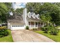 Charming two-story home with red shutters, landscaped front yard, and two-car garage at 117 Berringer Dr, Goose Creek, SC 29445