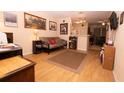 Cozy living room featuring wood floors, a futon, and decorative artwork at 1211 Meadow Park Ln # B, Mount Pleasant, SC 29464