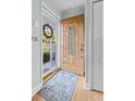 Elegant wood front door with decorative glass, offering a glimpse of the home's interior at 1351 Winifred St, Mount Pleasant, SC 29464