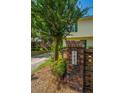 Townhome exterior featuring a brick pillar displaying '1423' and a glimpse of the yellow siding and green door at 1423 Ashley River Rd # 3A, Charleston, SC 29407