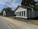 Charming home exterior with updated siding, large windows, and a well-maintained mailbox at 1488 Remount Rd, North Charleston, SC 29406