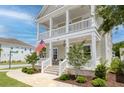 Inviting home exterior featuring a double porch, manicured landscaping, and a warm, welcoming ambiance at 1535 Low Pk St, Mount Pleasant, SC 29464