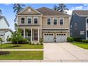 Charming two-story home featuring a welcoming front porch and a convenient two-car garage at 154 Calm Water Way, Summerville, SC 29486