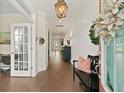 Inviting foyer with shiplap walls, hardwood floors, and a decorative wreath on the front door at 154 Calm Water Way, Summerville, SC 29486
