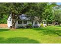 View of the house featuring a full front porch from the side, landscaped yard, and mature trees at 162 Whippoorwill Dr, Summerville, SC 29483