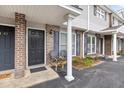 Charming covered front porch with seating area and well-manicured landscaping at 1713 Boone Hall Dr # 1082, Charleston, SC 29407