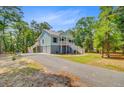 Attractive raised beach house with a lush tree lined yard, and private drive at 18 Tupelo Trl, Edisto Island, SC 29438