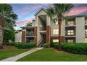 Apartment building featuring exterior stairs, a landscaped lawn, and mature trees at 2011 N Highway 17 # 1400A, Mount Pleasant, SC 29466