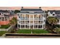 Spacious multi-story beach house featuring multiple balconies for enjoying scenic views and outdoor living at 210 Ocean Blvd, Isle of Palms, SC 29451