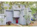 Charming two-story home with grey siding, a red front door, and a beautifully landscaped front yard at 2159 Spoleto Ln # E, North Charleston, SC 29406