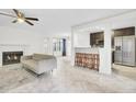 Open-concept living space with a fireplace, bar seating, and a view into the kitchen with stainless appliances at 2159 Spoleto Ln # E, North Charleston, SC 29406